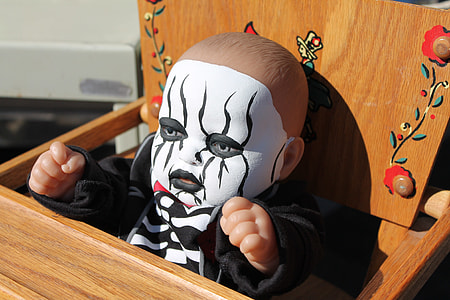 doll in black suit sitting on brown wooden highchair thumbnail
