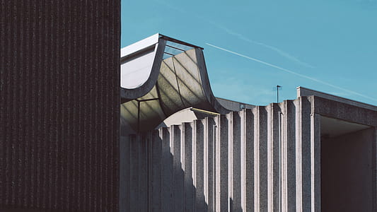 gray concrete structure under sunny sky thumbnail