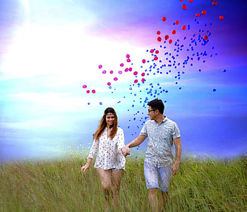 couple walking on grassy field thumbnail