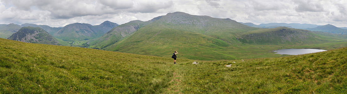 landscape photography of green grass field near mountains thumbnail