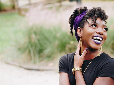 smiling woman near green grasses during daytime thumbnail