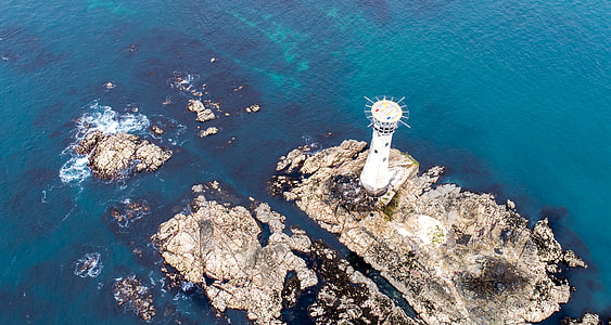 aerial view photography of lighthouse surrounded of body of water thumbnail