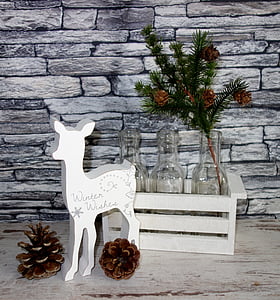 brown pine cones beside white deer figurine thumbnail