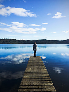 photo of man standing on bridge thumbnail