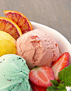 ice cream surrounded with slice strawberry and orange thumbnail