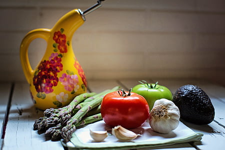 vegetables and spices and yellow floral bottle on surface thumbnail