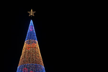 blue and orange Christmas tree under black sky thumbnail
