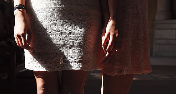 two women standing next to each others thumbnail