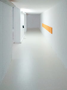 white concrete wall with orange wall decor thumbnail