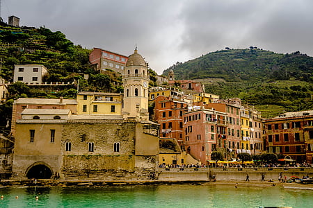 brown concrete building beside body of water thumbnail
