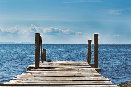 brown wooden dock near ocean at daytime thumbnail