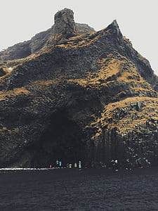 mountain peak near body of water thumbnail