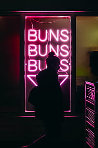 silhouette of person standing in front of purple LED signage thumbnail