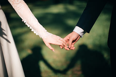 bride and groom holding each others' hands thumbnail
