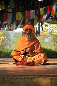 man sitting wearing orange dress thumbnail