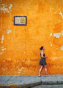 woman facing right near wall on pavement outdoors thumbnail