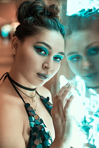 woman wearing black halter strap bra while leaning on glass thumbnail