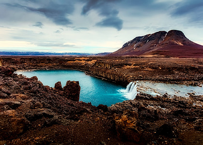 waterfalls within mountain range during daytime thumbnail