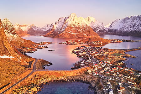 aerial photo of houses far mountain beside body of water thumbnail