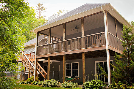 brown 2-storey building surrounded tall trees thumbnail