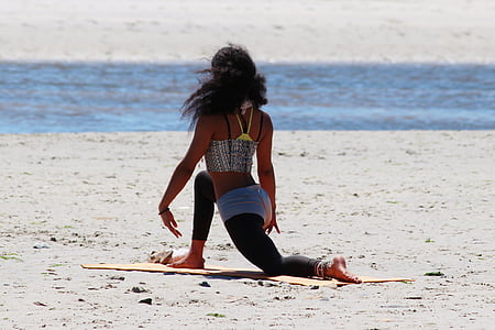 woman doing yoga near body of water thumbnail