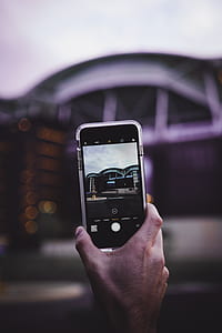 shallow focus photography of iPhone camera capturing grey building thumbnail