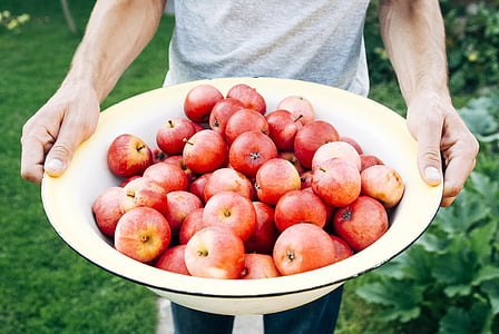 person carrying basin of apples thumbnail