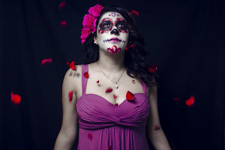 woman wearing pink lace dress looking up while rose petaled dropping thumbnail