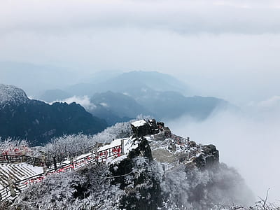 brown house on mountain with cloudy sky thumbnail