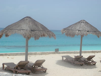 two gray gazebos near beach thumbnail