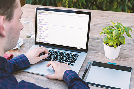 person holding gray laptop computer thumbnail