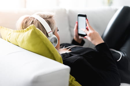 Woman Listening to Music on a Sofa thumbnail