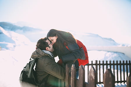 man and woman facing each other near fence thumbnail