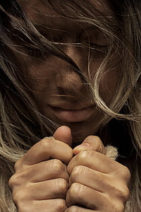 close up photo of person closing eyes and closed hand thumbnail