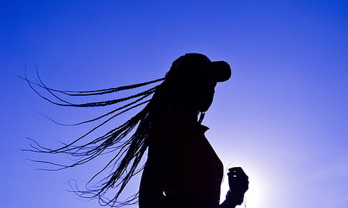 Silhouette of Woman Wearing Cap thumbnail