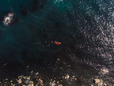 aerial photography of person riding boat on body of water during daytime thumbnail