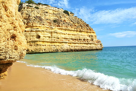 beige rock formation near seashore thumbnail