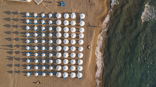 aerial view photography of white umbrella lot on beach thumbnail