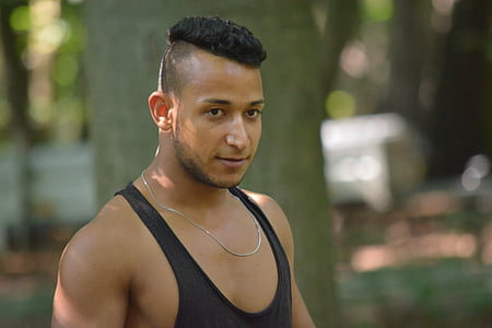 selective focus photography of man wearing black tank top thumbnail
