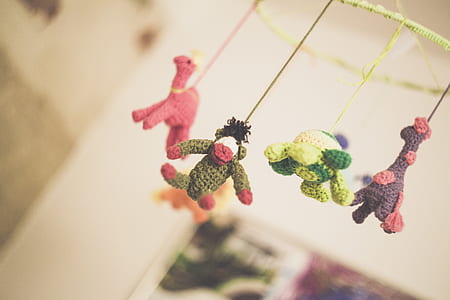 four knit dolls in tilt shift photography thumbnail