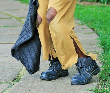 person wearing distressed yellow pants and black boots thumbnail