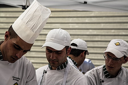 four men wearing white chef uniform inside room thumbnail
