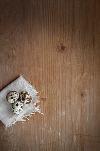 three quell eggs on gray textile thumbnail