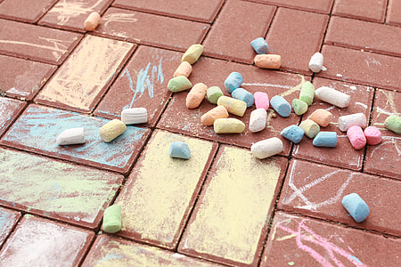 assorted-color chalks on brown concrete pavement thumbnail