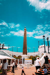 People Walking Beside Obelisk Tower thumbnail