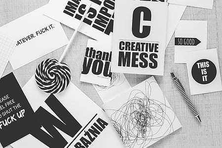 photo of Creative mess paper beside pen and lollipop thumbnail