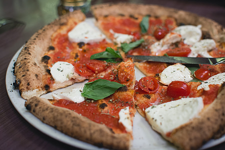 slice pizza with tomato and white cheese on top dish thumbnail