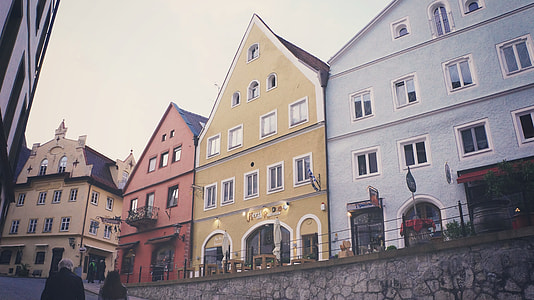 building near slope road with people walking during daytime thumbnail