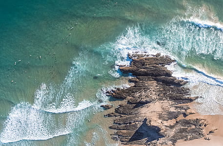 bird's-eye view photo of sea waves crashing on shore thumbnail