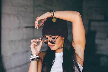 women's wearing black bonet and black frame sun glasses thumbnail
